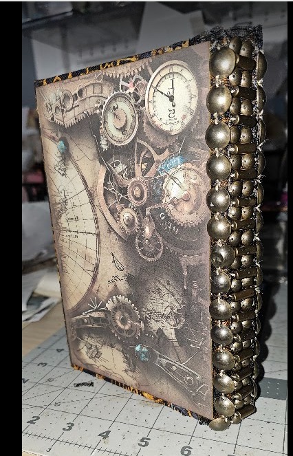 Clock-themed journal detail with decorative metal trim along the edge